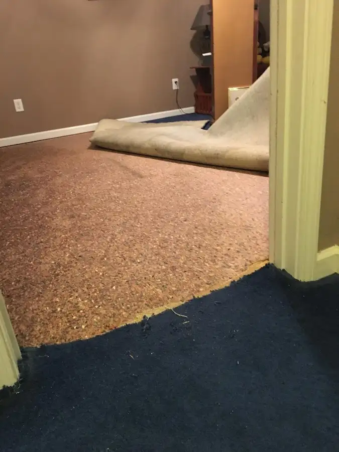 Carpet pad removal revealing water damage during Water Mitigation Services in Airmont